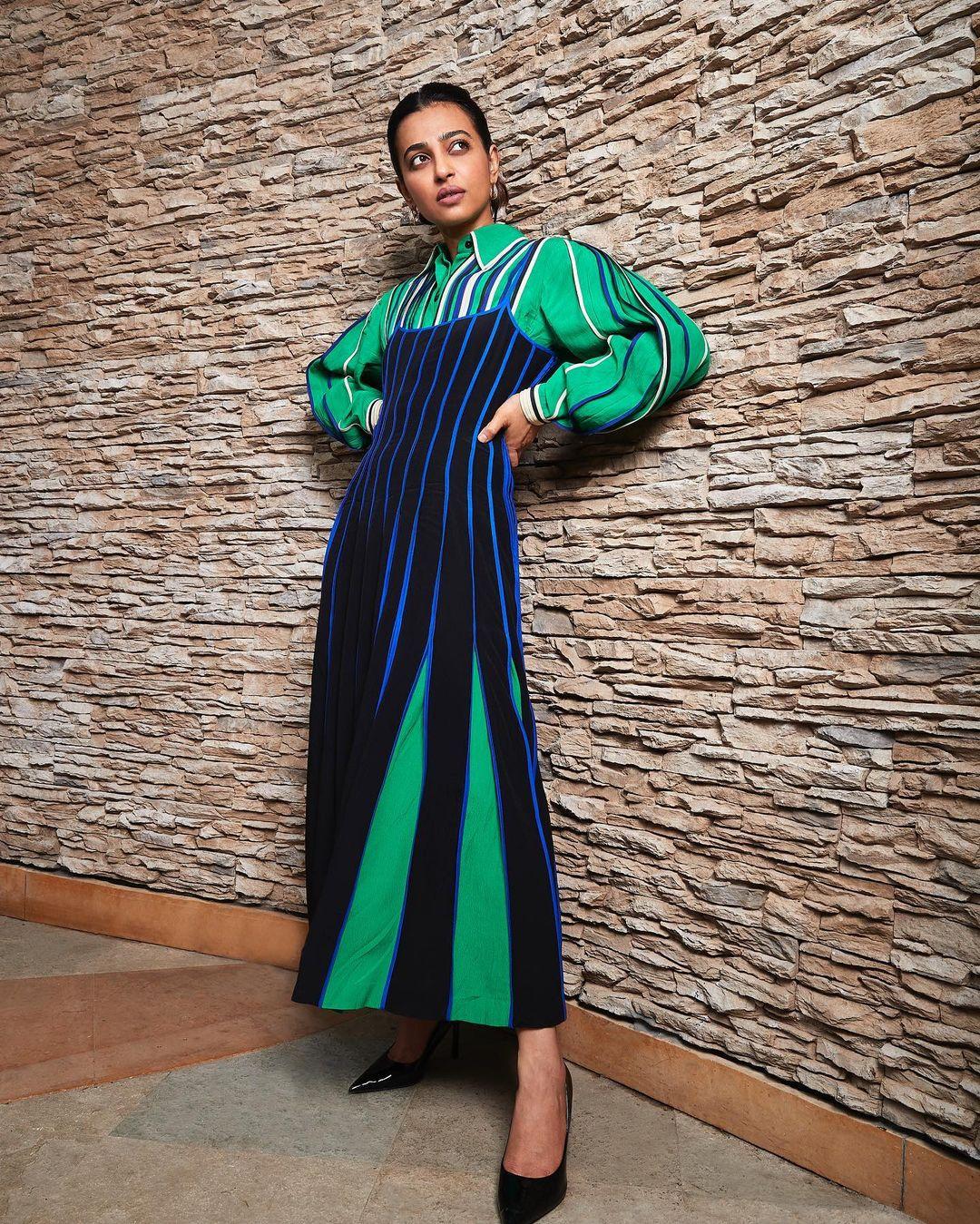 The pleated dress flows with relaxed grace, creating an ethereal yet comfortable silhouette.